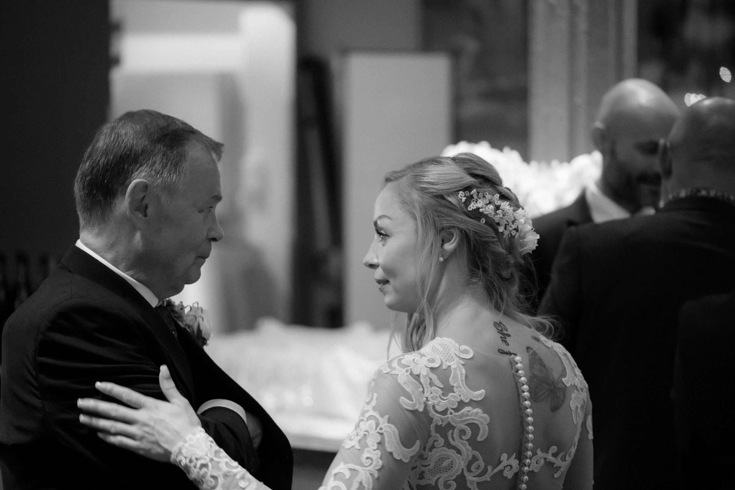 Black and white photograph of guests dancing and celebrating at a formal event.