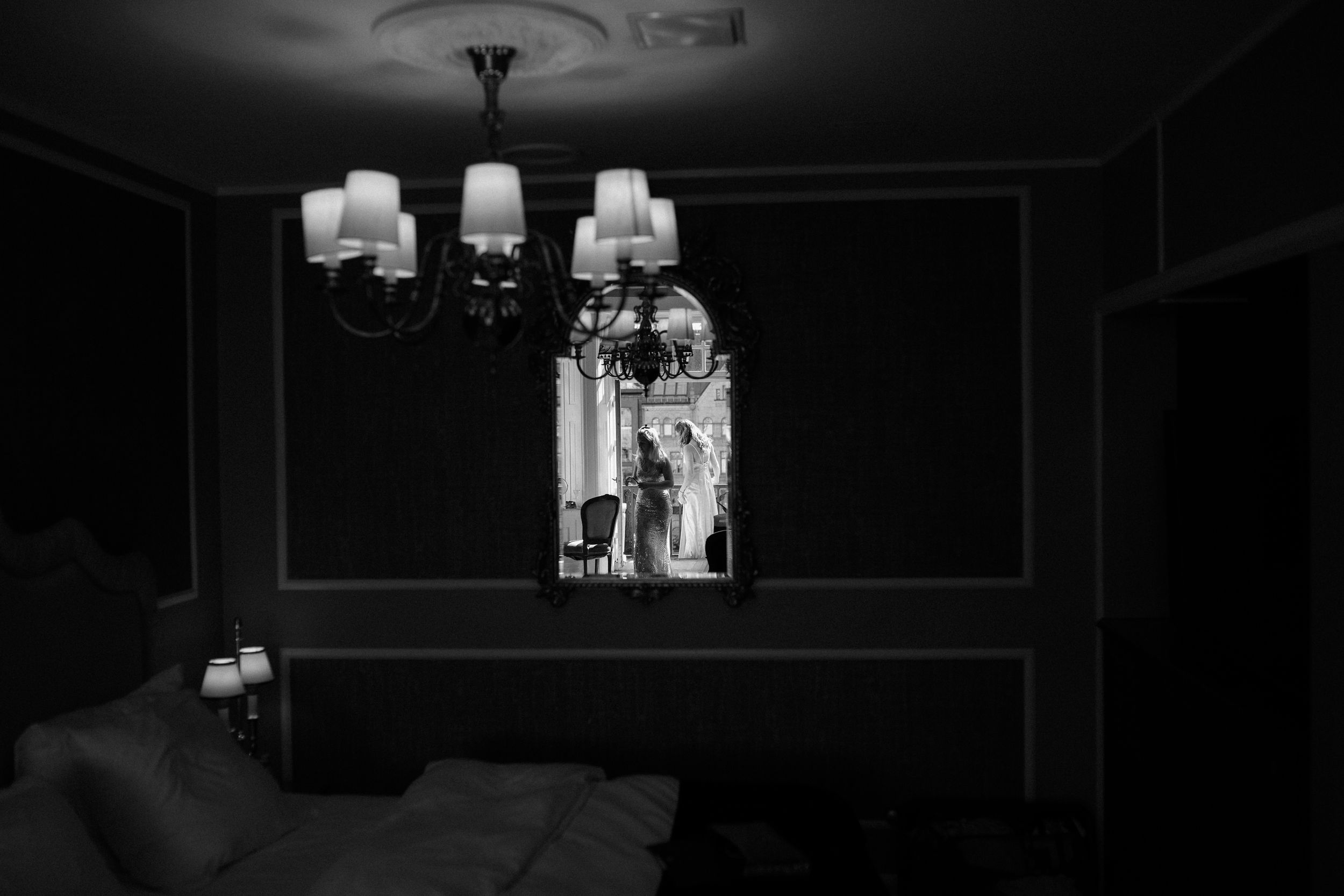 A series of black and white wedding photos arranged in dark vintage frames.
