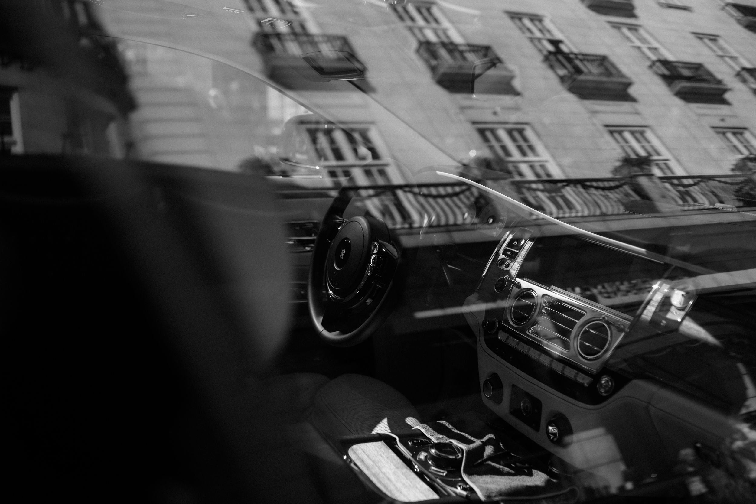 High contrast black and white montage featuring vintage film cameras and photography equipment against dark background.