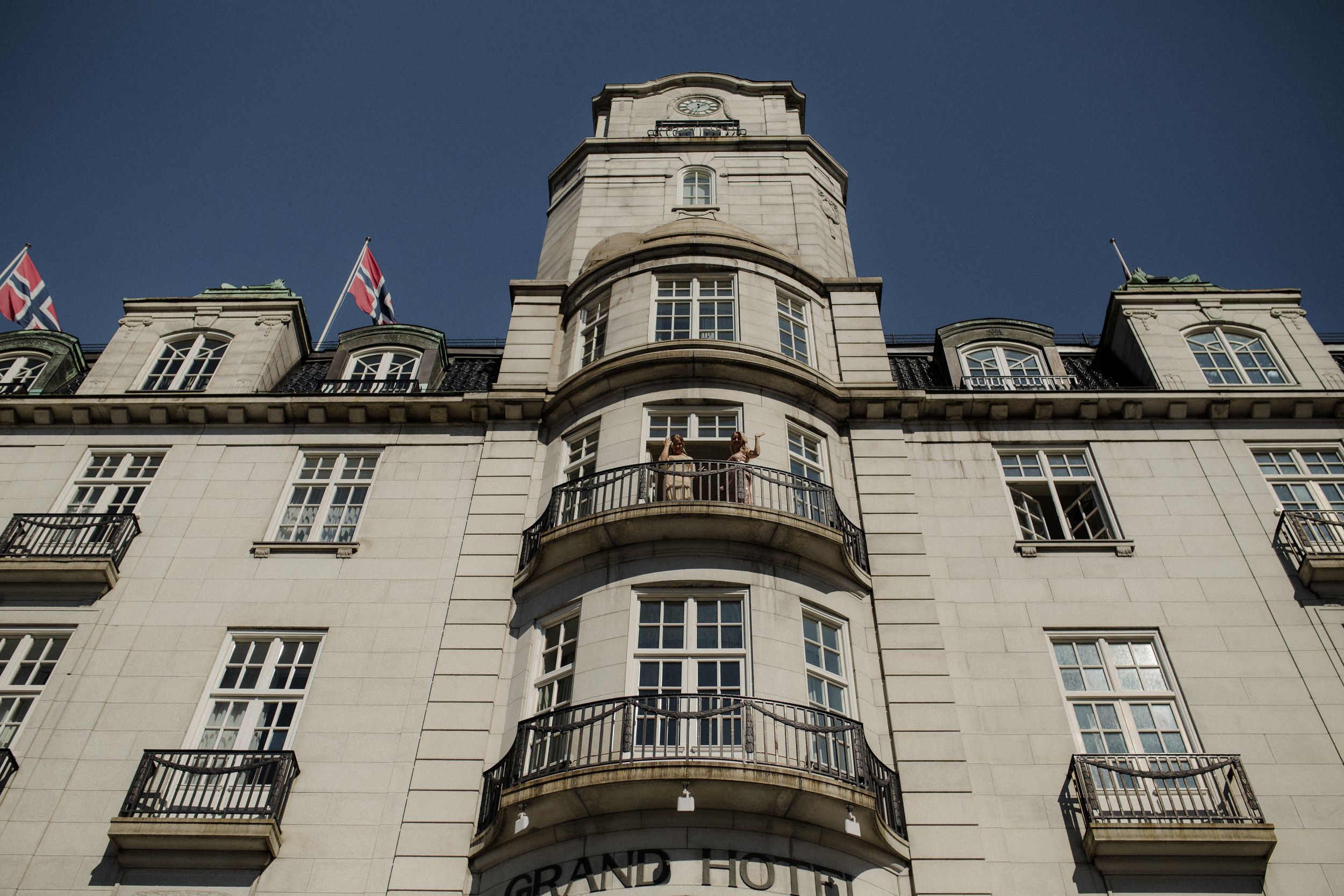Historic stone building exterior with ornate balconies and classical architecture.