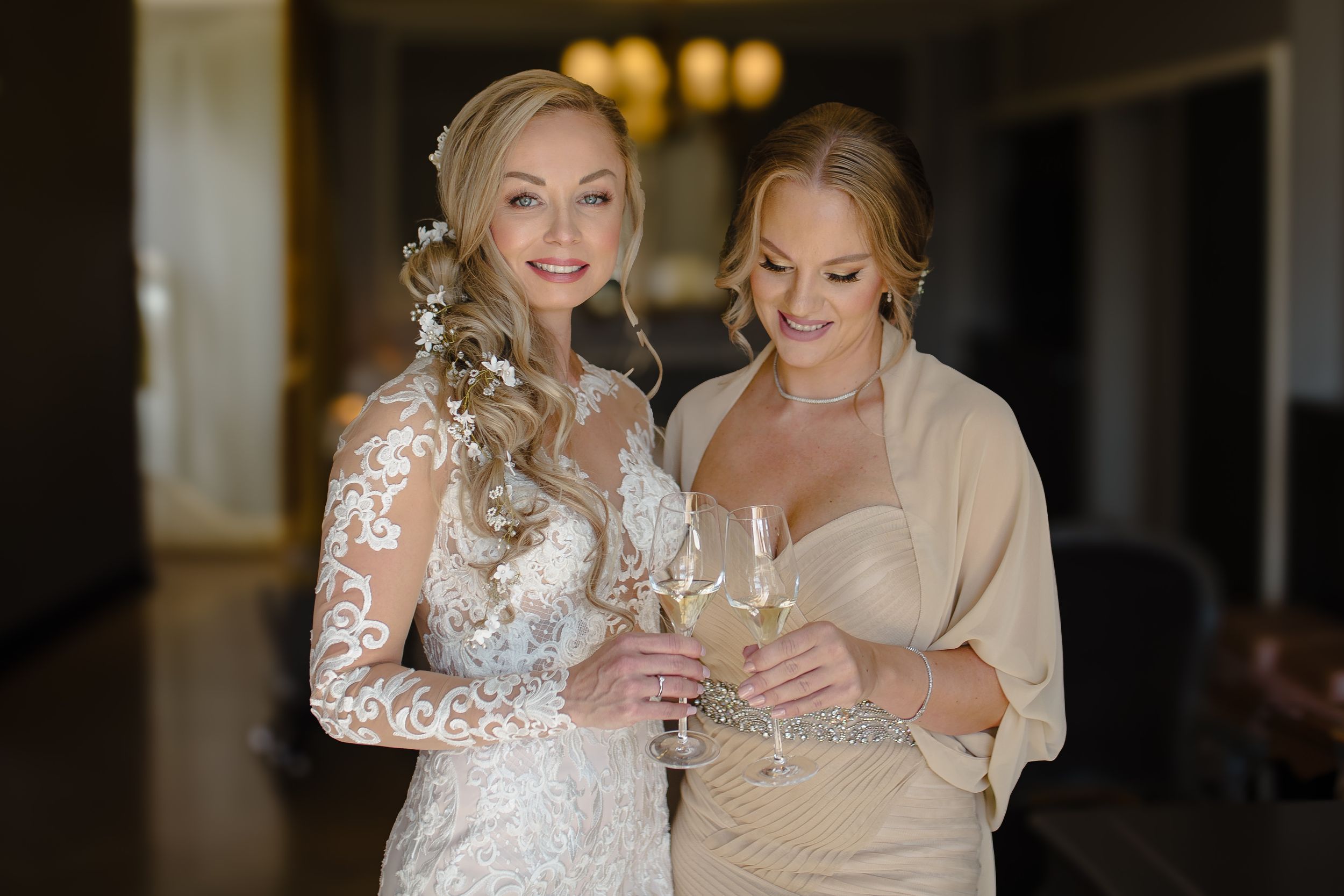 Two people sharing joyful moments in formal attire during a wedding celebration.