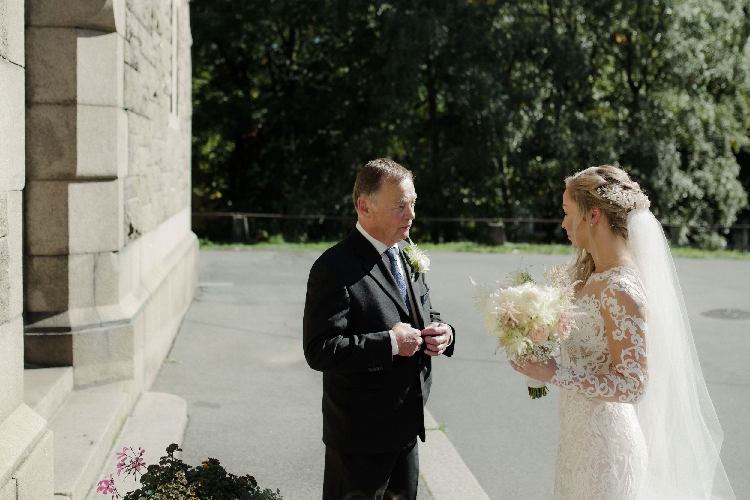 Newlywed couple celebrates their special day in six romantic outdoor wedding portraits under a stone archway.