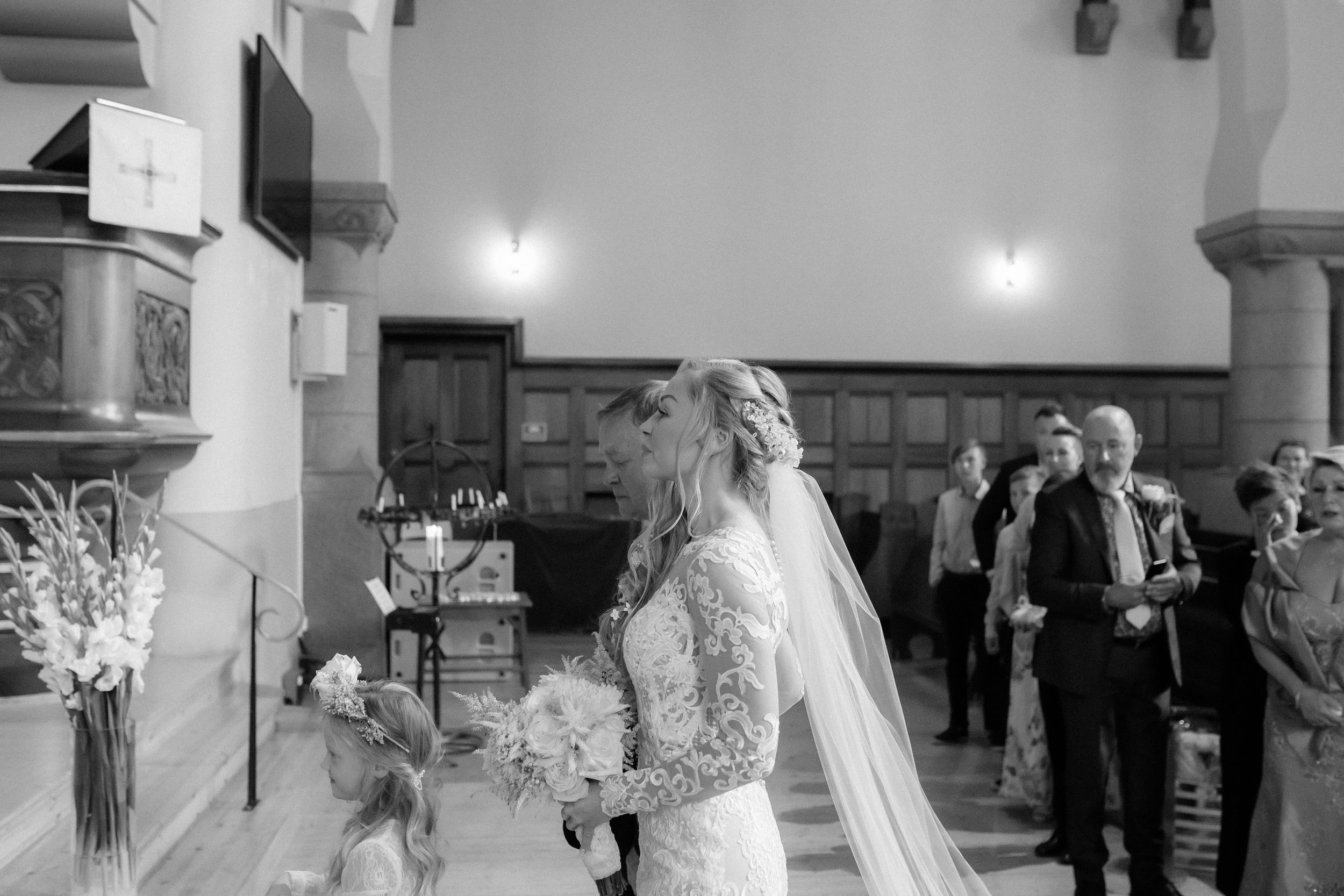 Several wedding ceremony photos showing couples and wedding guests celebrating inside an elegant church venue with high ceilings.