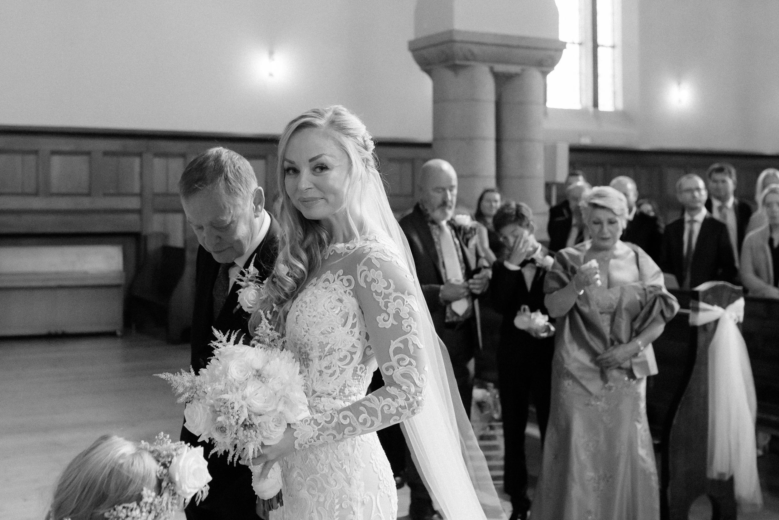 A bride and groom share their first dance together in an elegant church venue during their wedding reception.