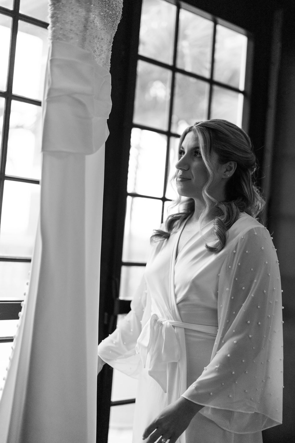A sequence of ethereal bridal portraits showing a flowing white dress and veil in a window-lit corridor.