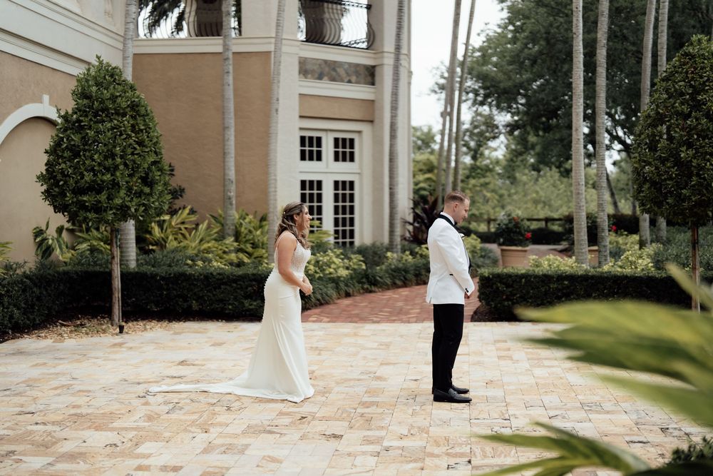Elegant outdoor wedding first look sequence with Mediterranean architecture and palm trees.