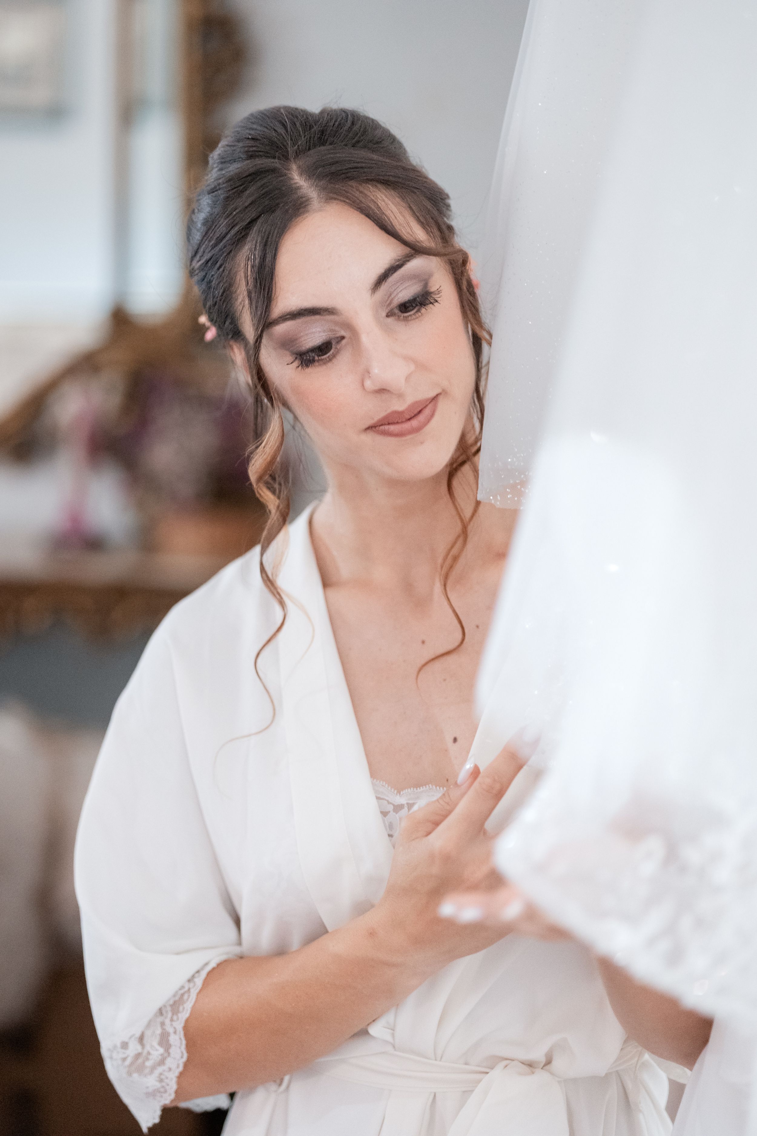 A series of close-up shots showing bridal preparations with delicate lace details and jewelry.