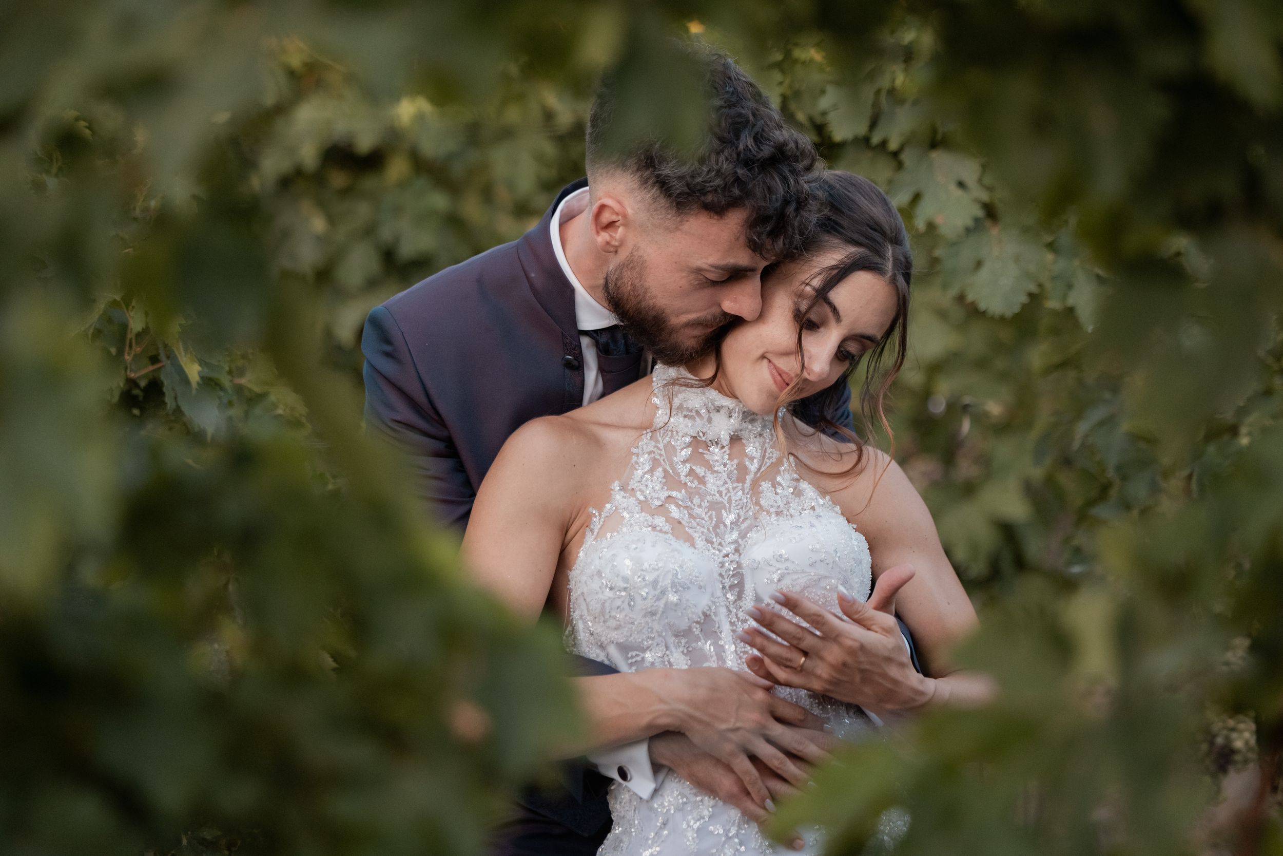Bride and groom share an intimate embrace while dancing during their wedding reception.