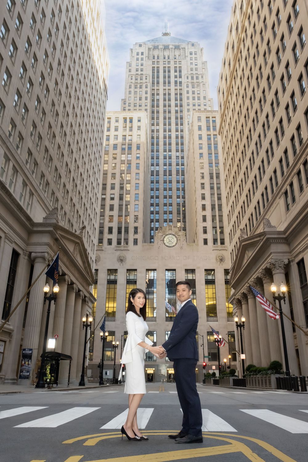 Art deco skyscrapers frame an outdoor proposal scene at Rockefeller Plaza in downtown Manhattan.