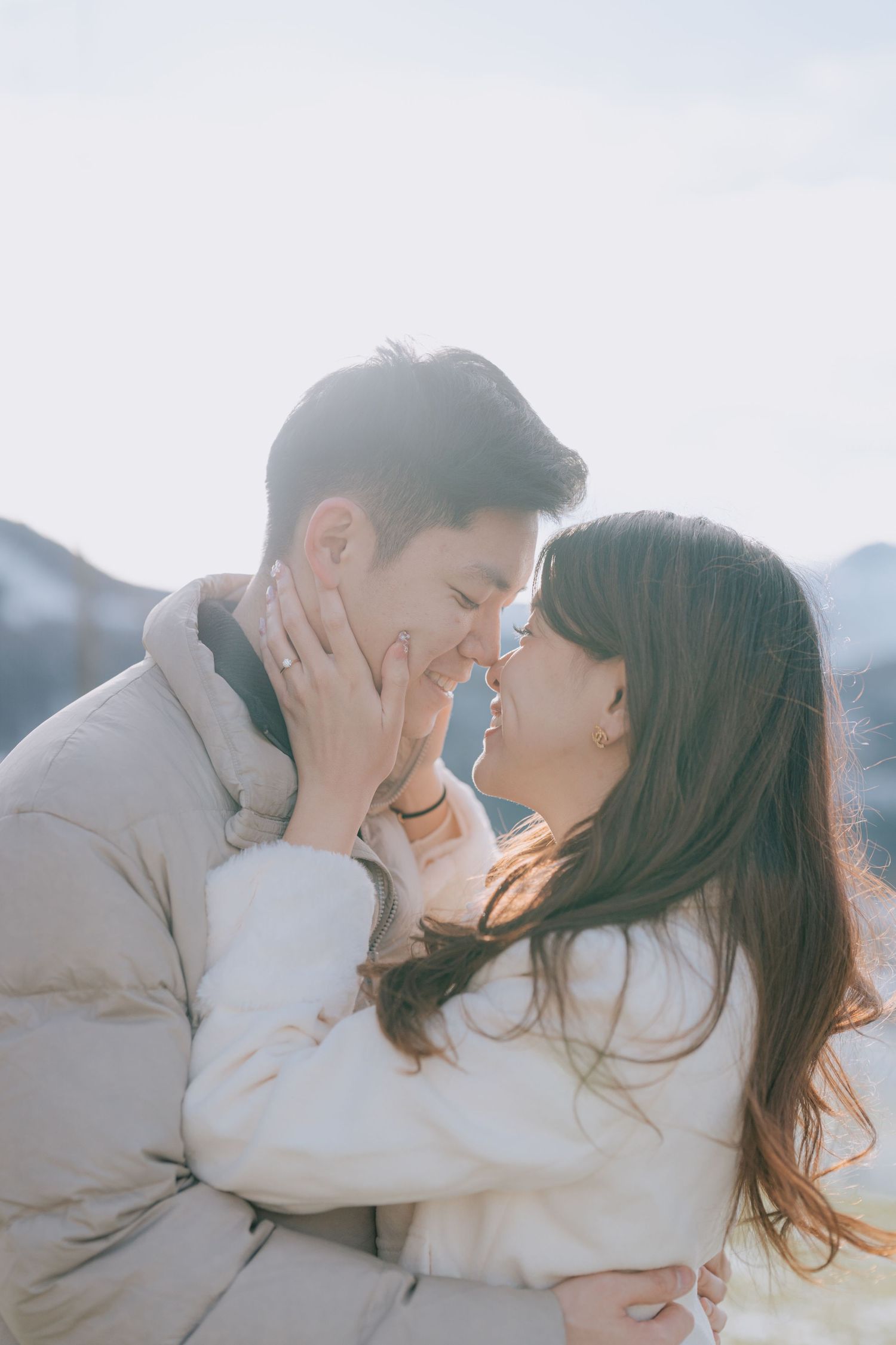A romantic couple sharing intimate moments in a dreamy outdoor setting during golden hour.