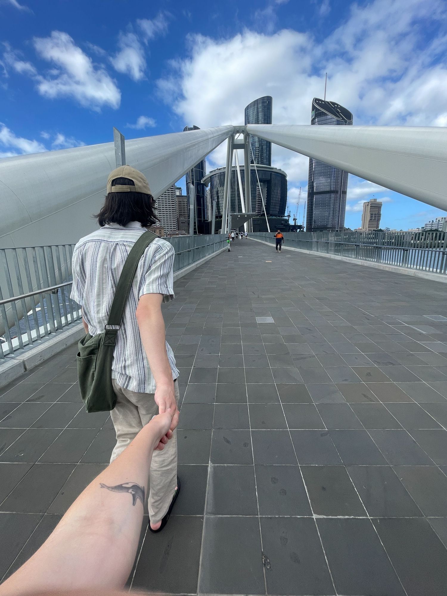 Low-angle sequence of parkour movements on a modern rooftop terrace with city skyline in background.