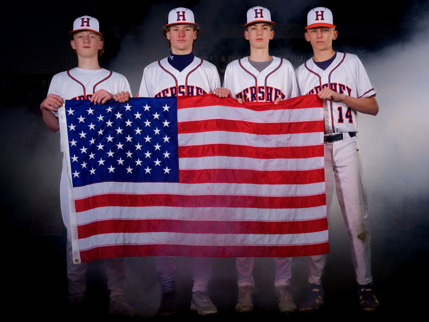 Hershey High School baseball players holding American flag for Media Day, by Deanna Fox, SportsFox Photography, Hershey PA