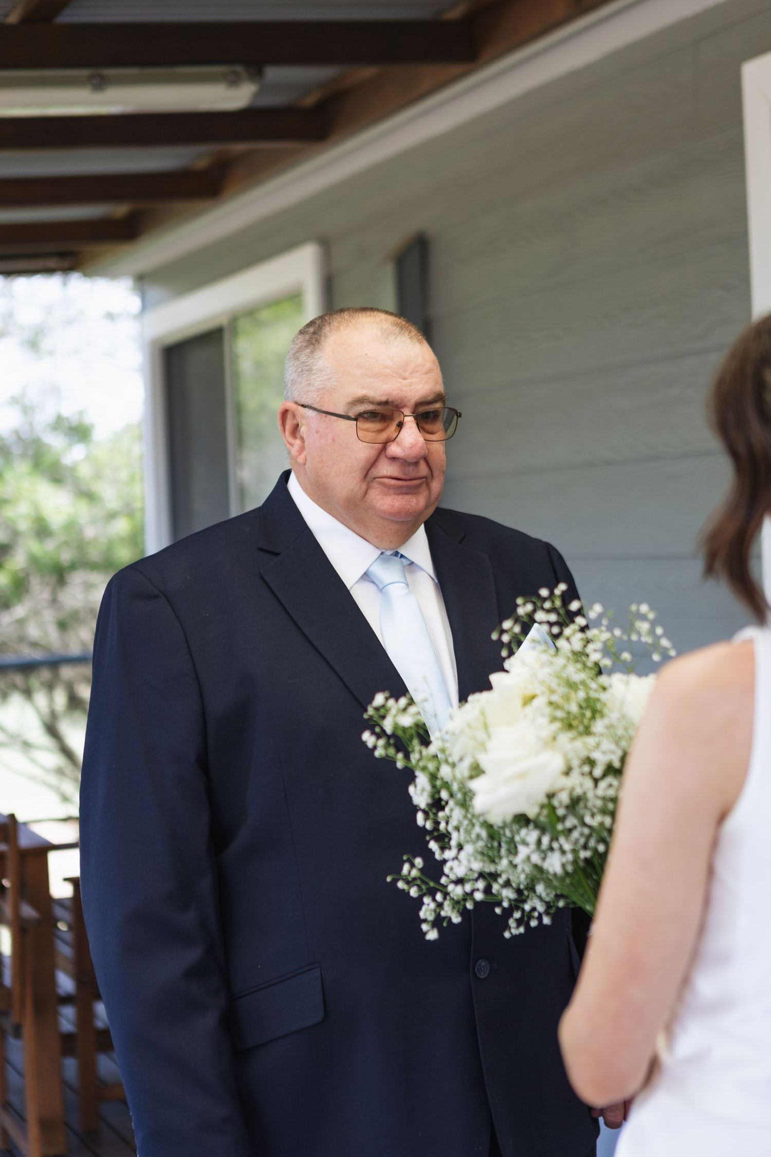father of the bride crying during first look with his daughter at two rivers winery wedding denman