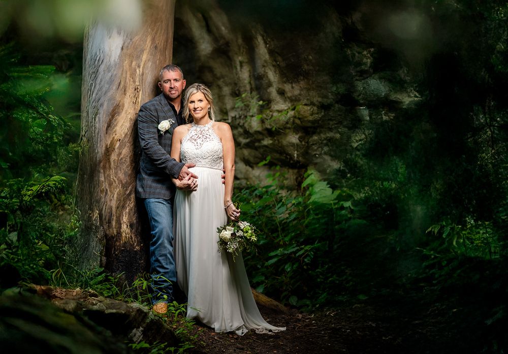 Bride and groom portrait beside a tall tree in the Ozark woods during their Mirror Lake elopement, Mountain View, Arkansas