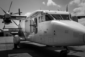 Black and white photo of an Air Cargo Carriers turboprop aircraft parked on tarmac.