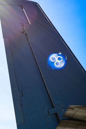 Air Cargo Carriers logo on a dark aircraft tail fin against a bright blue sky.