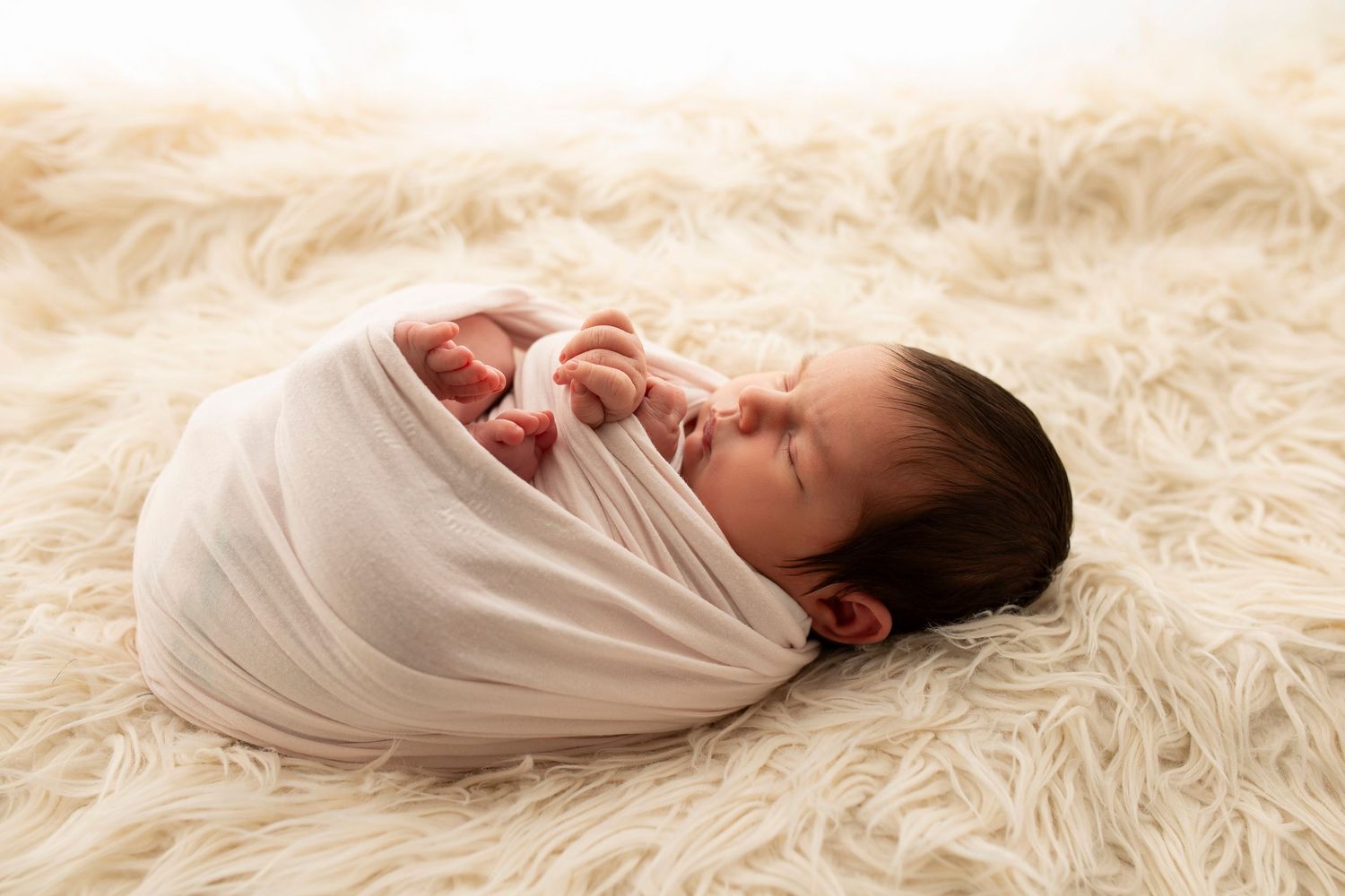 newborn baby wrapped for photoshoot by little wonderland photography widnes cheshire warrington