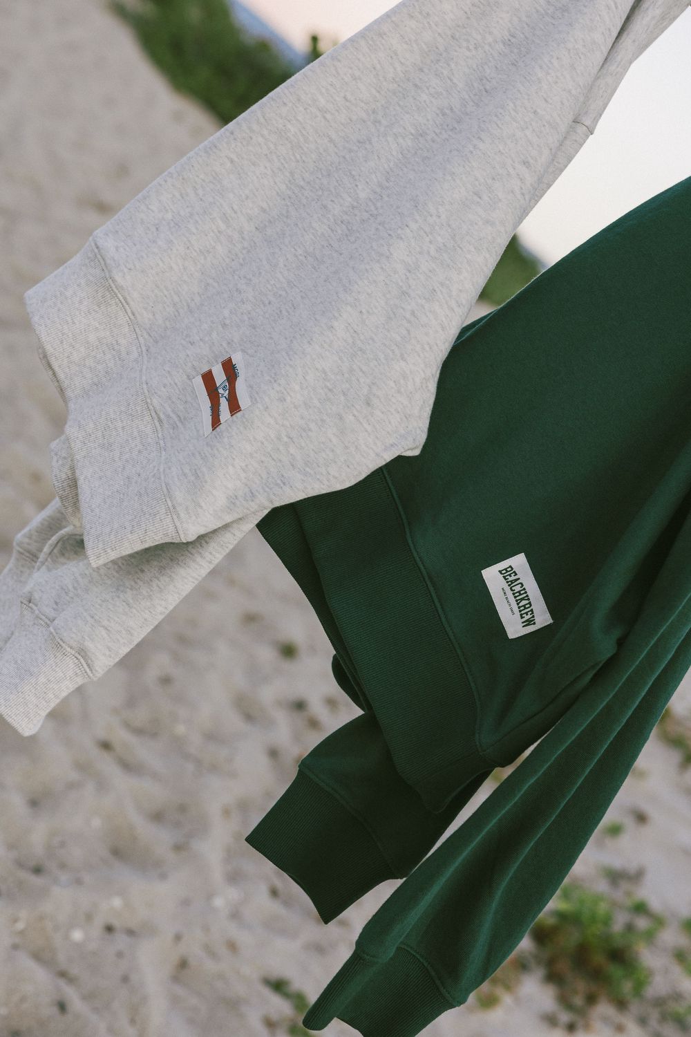 Close-up detail of white and green clothing fabric with small brown accent tag.