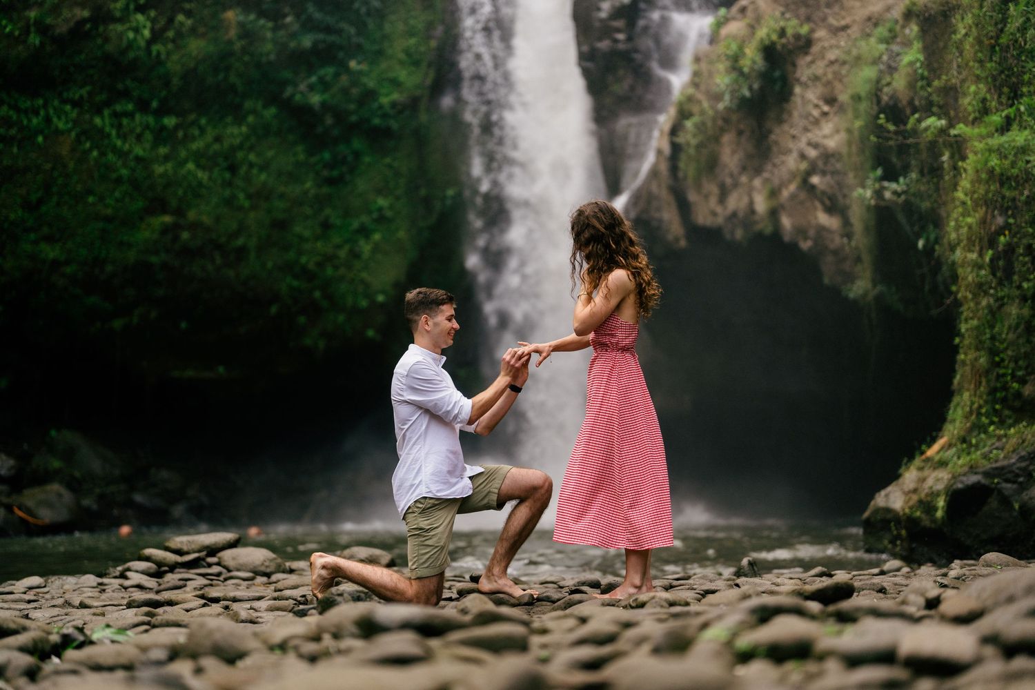 Romantic engagement photoshoot at Tegenungan Waterfall with natural scenery