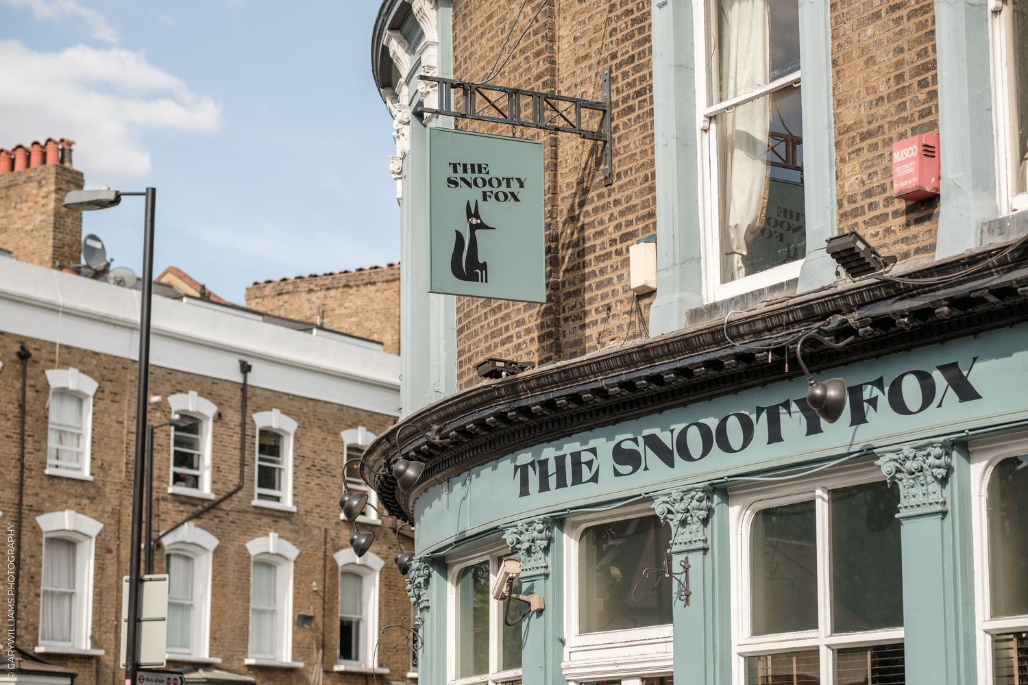 The Snoot Fox pub sign and facade on a sunny day in London, England.