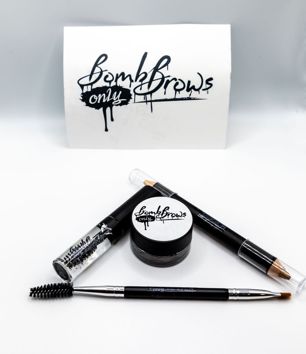 BombBrows beauty product set featuring eyebrow pomade, brushes and applicators on white background.