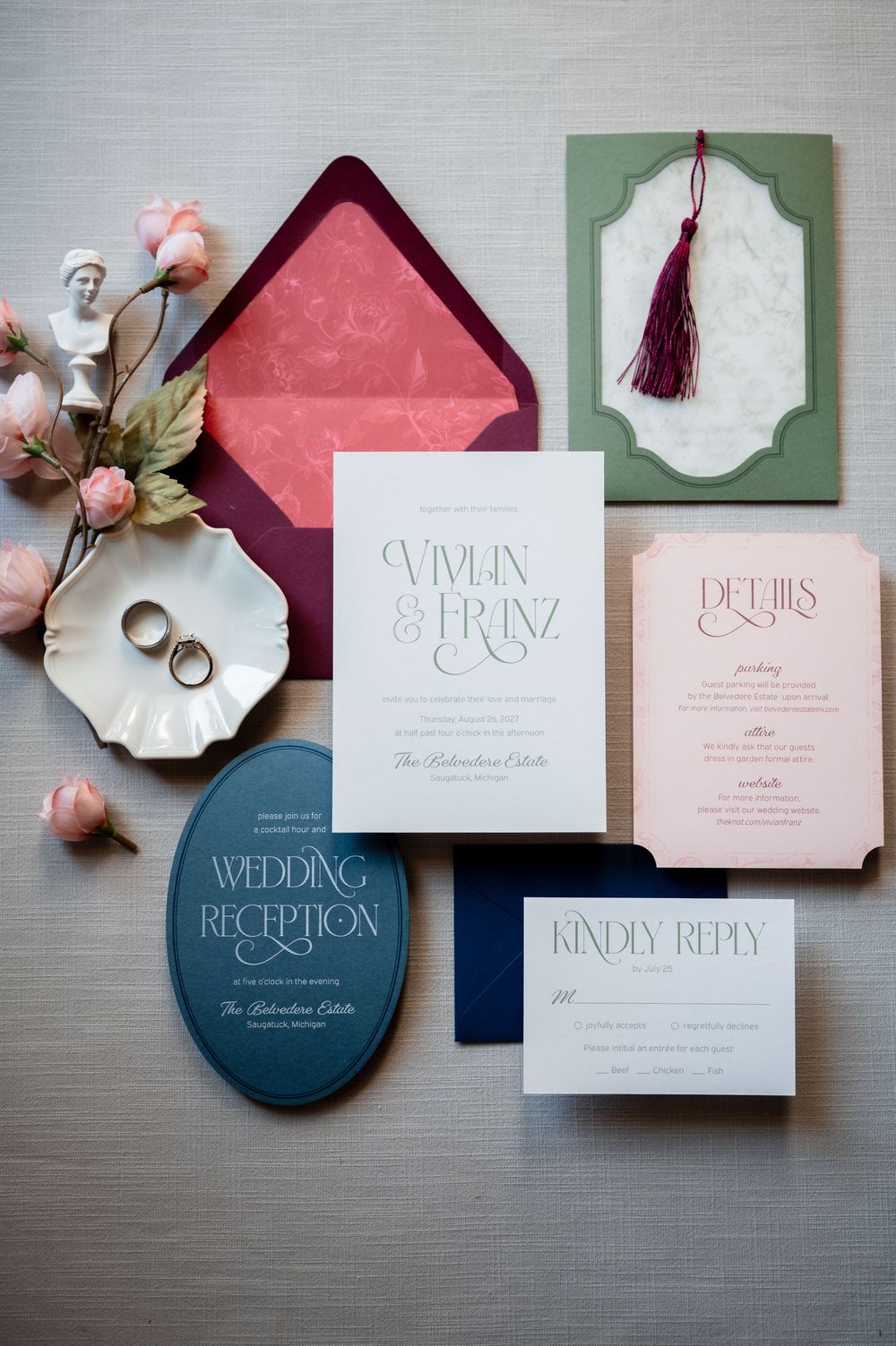 Elegant wedding invitation suite with sage green, blush pink, and navy accents, featuring tassel details and floral envelope liner.