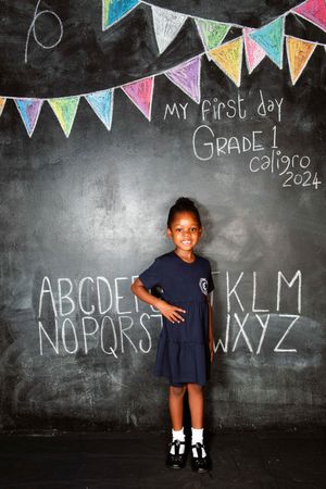 Student in school uniform posing for a portrait at Caligro.