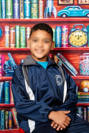 An image of a school boy smiling at the camera for their school portrait in Pretoria.