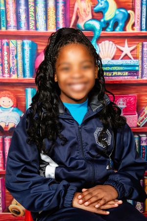 An image of a Preschool learner smiling for their portrait photo.