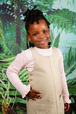 An image of a pre-primary school learner posing for their preschool portrait.