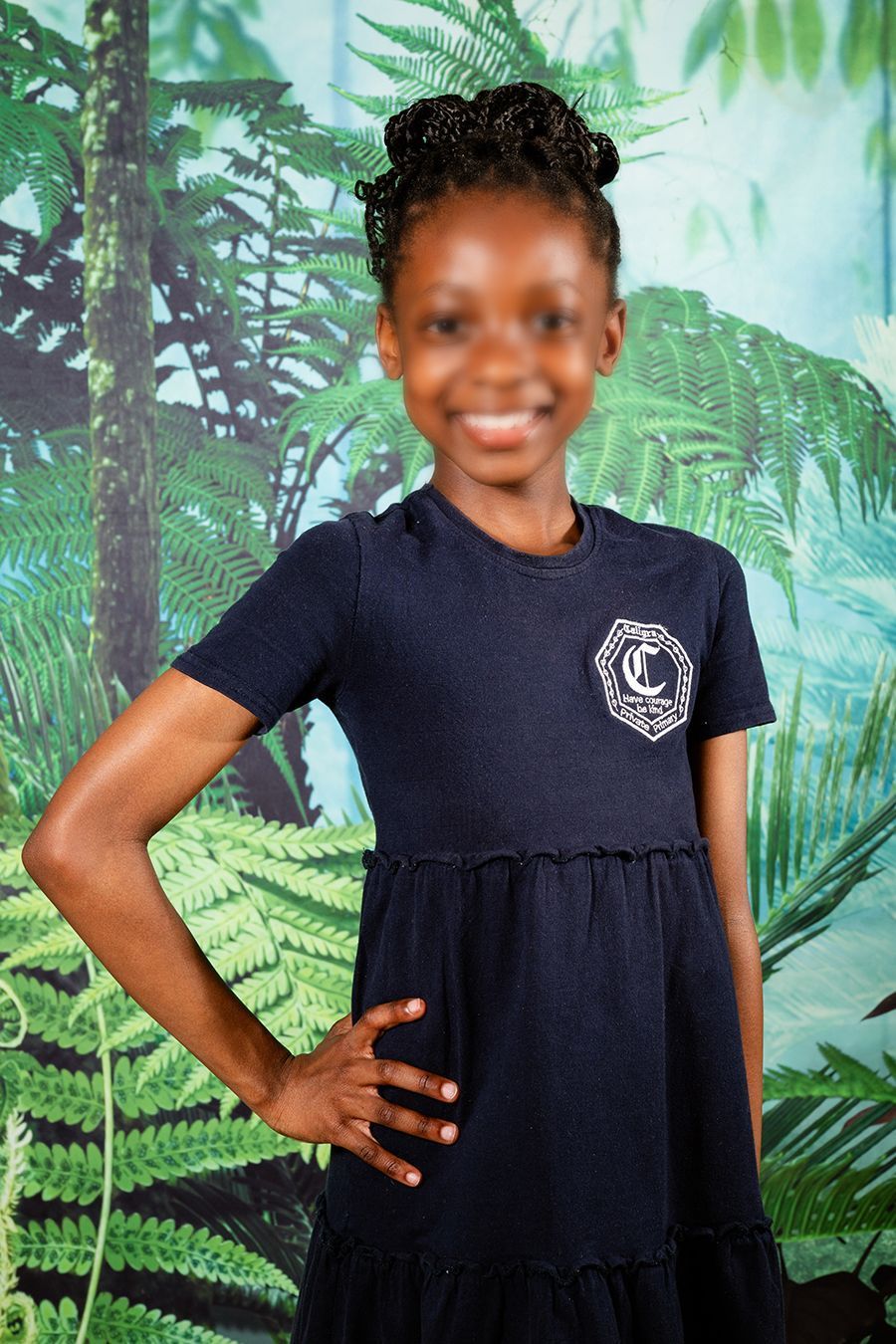 An image of a scholar smiling at the camera for picture day.