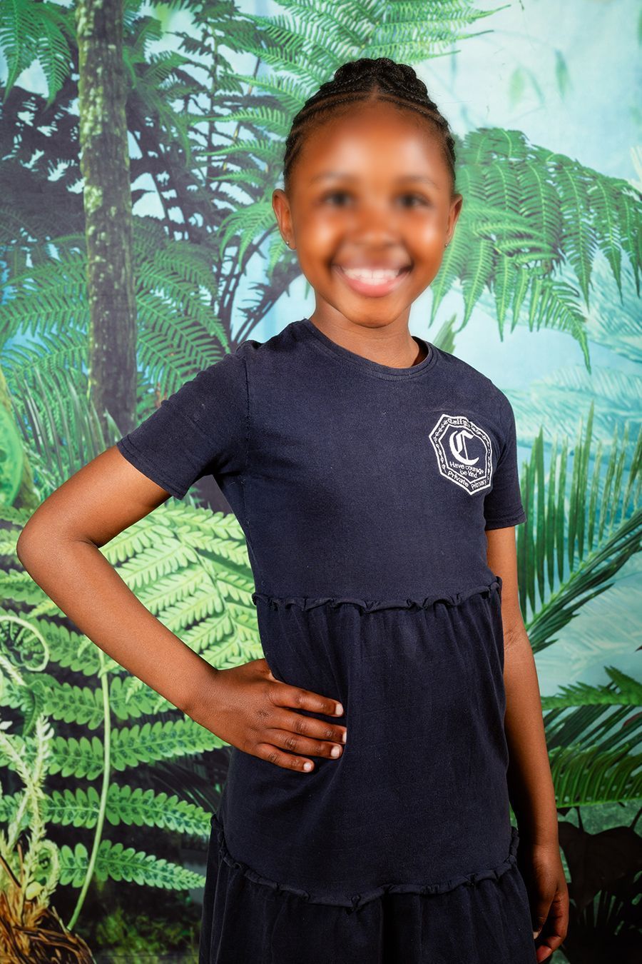 An image of a scholar smiling at the camera for picture day, image taken by Rynali Photography.