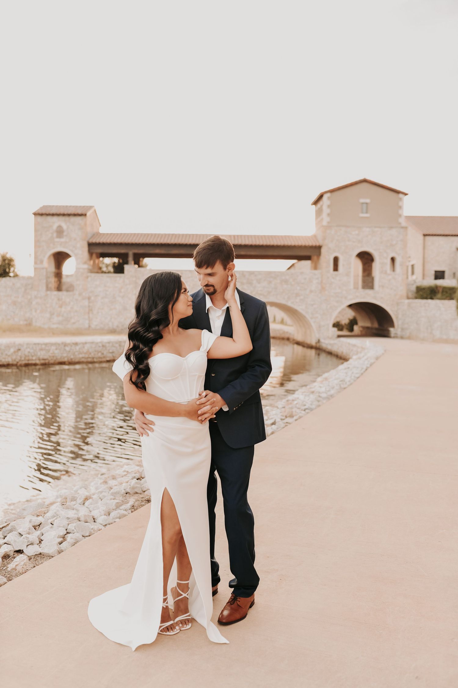 Sophisticated engagement portraits featuring a navy suit and flowing white dress