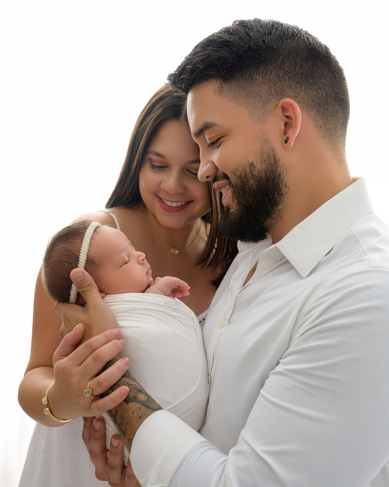 Parents holding their newborn baby during a family newborn photography session in Zephyrhills, Florida