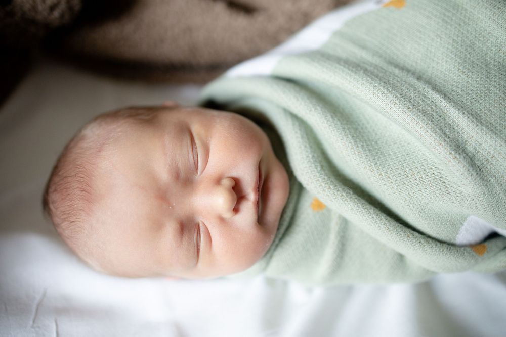 Peaceful newborn baby sleeping during fresh 48 session at the University of Tennessee with Nina Thomas Photography.