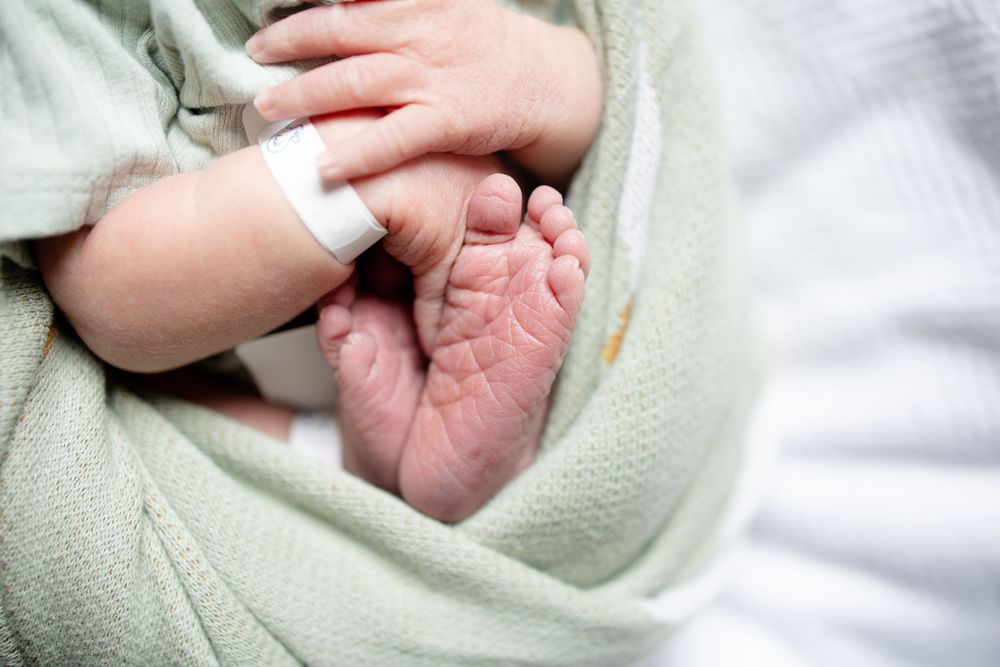 Newborn baby feet and hands during fresh 48 session at the University of Tennessee with Nina Thomas Photography.