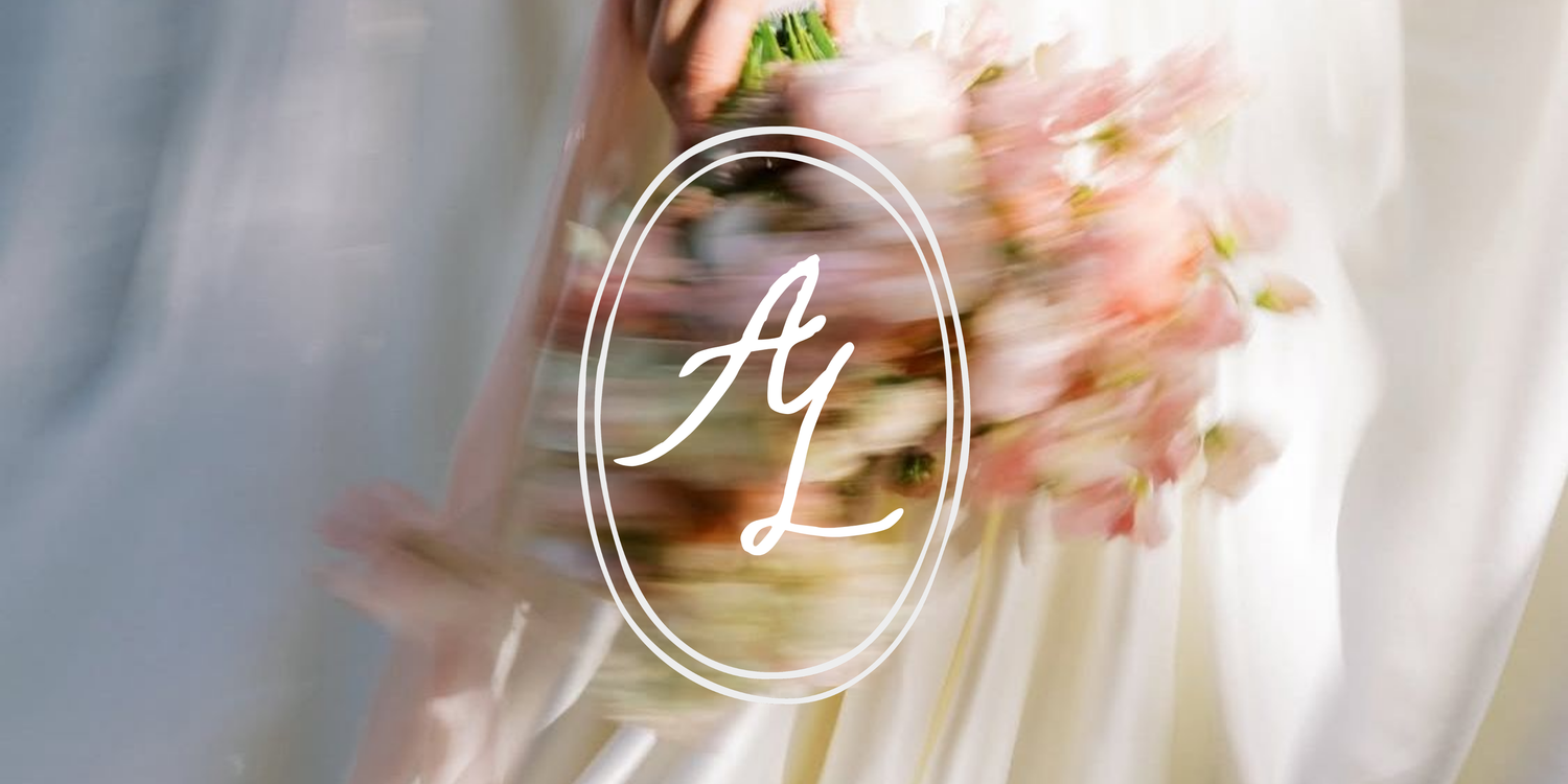 Elegant wedding logo with script initials on a soft floral bridal bouquet background.