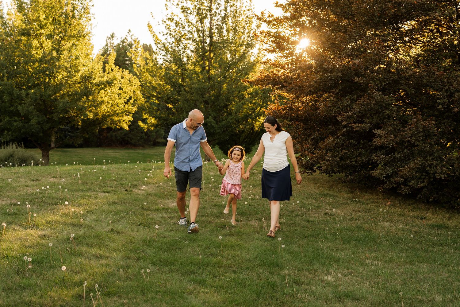 Daughter laughing with her parents during family photos
