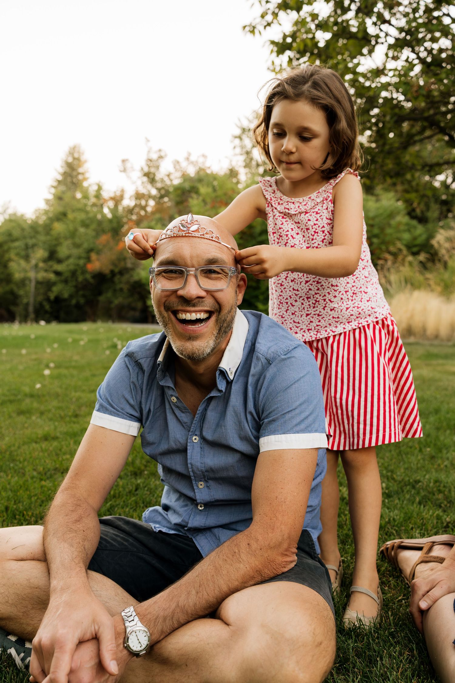 Dad smiling while spending time with his daughter