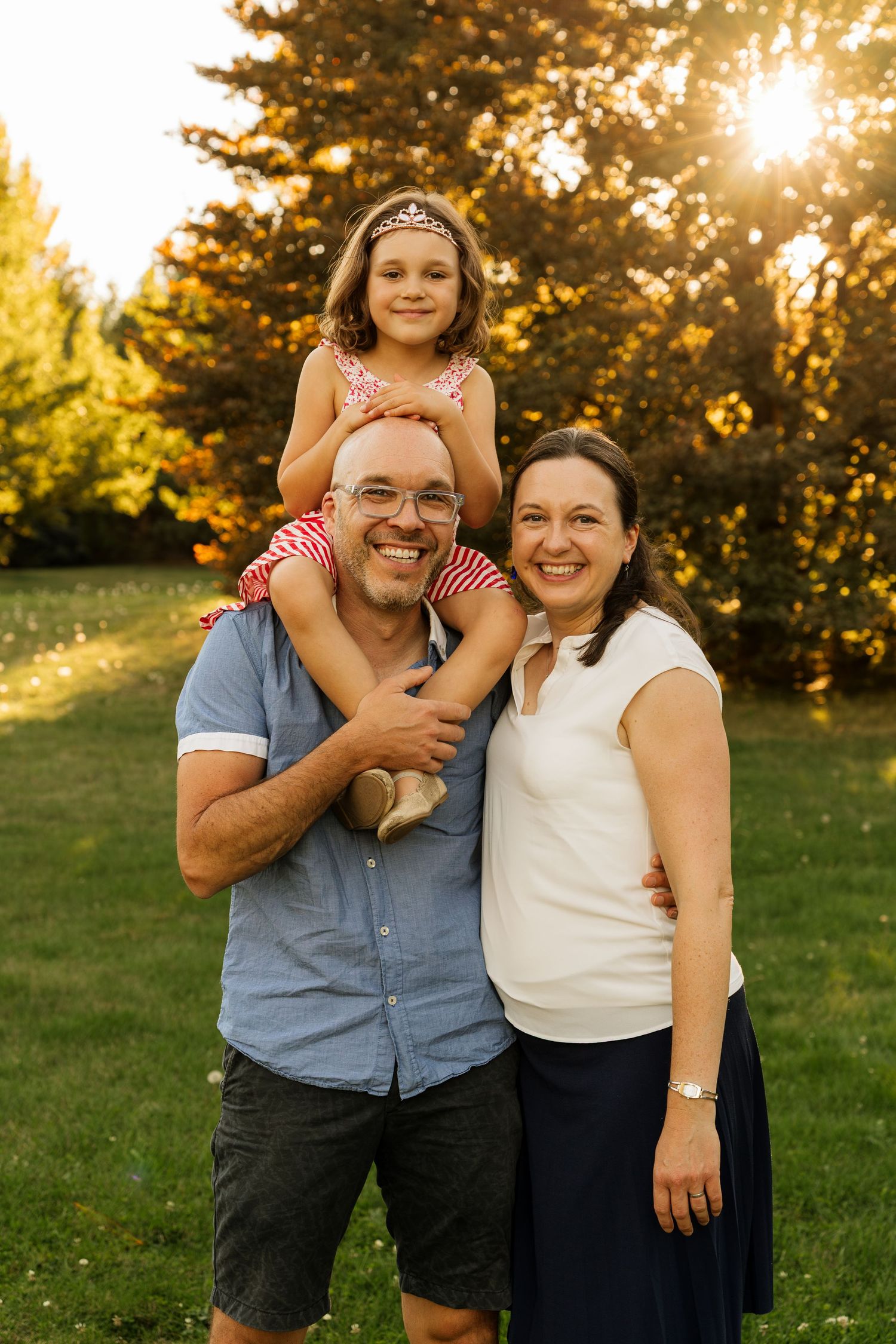 Natural family portrait of parents and daughter