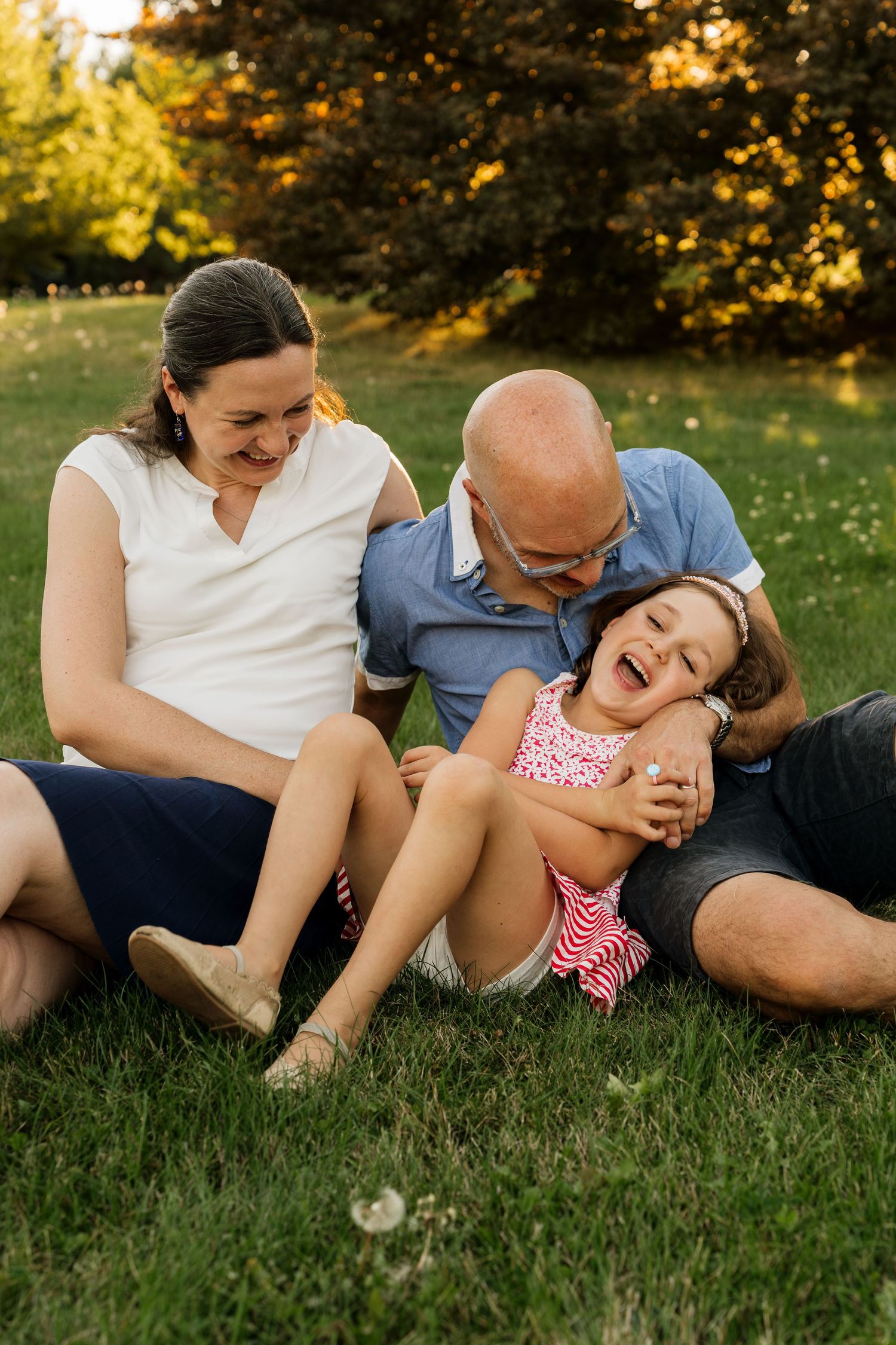 Family laughing together during an outdoor photo session