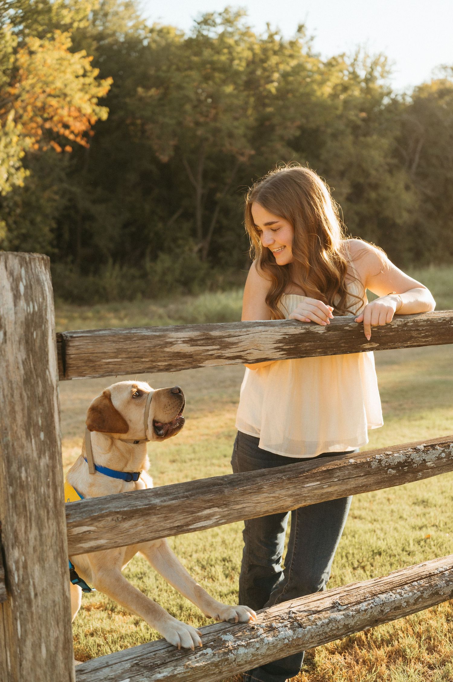 Candid senior portrait of Lauren running with Opus during her outdoor senior photo session