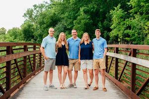 Photo of a family standing on a bridge