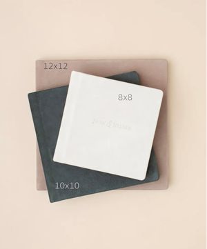 Three photo albums in sizes 12x12, 10x10, and 8x8 stacked on a beige background.