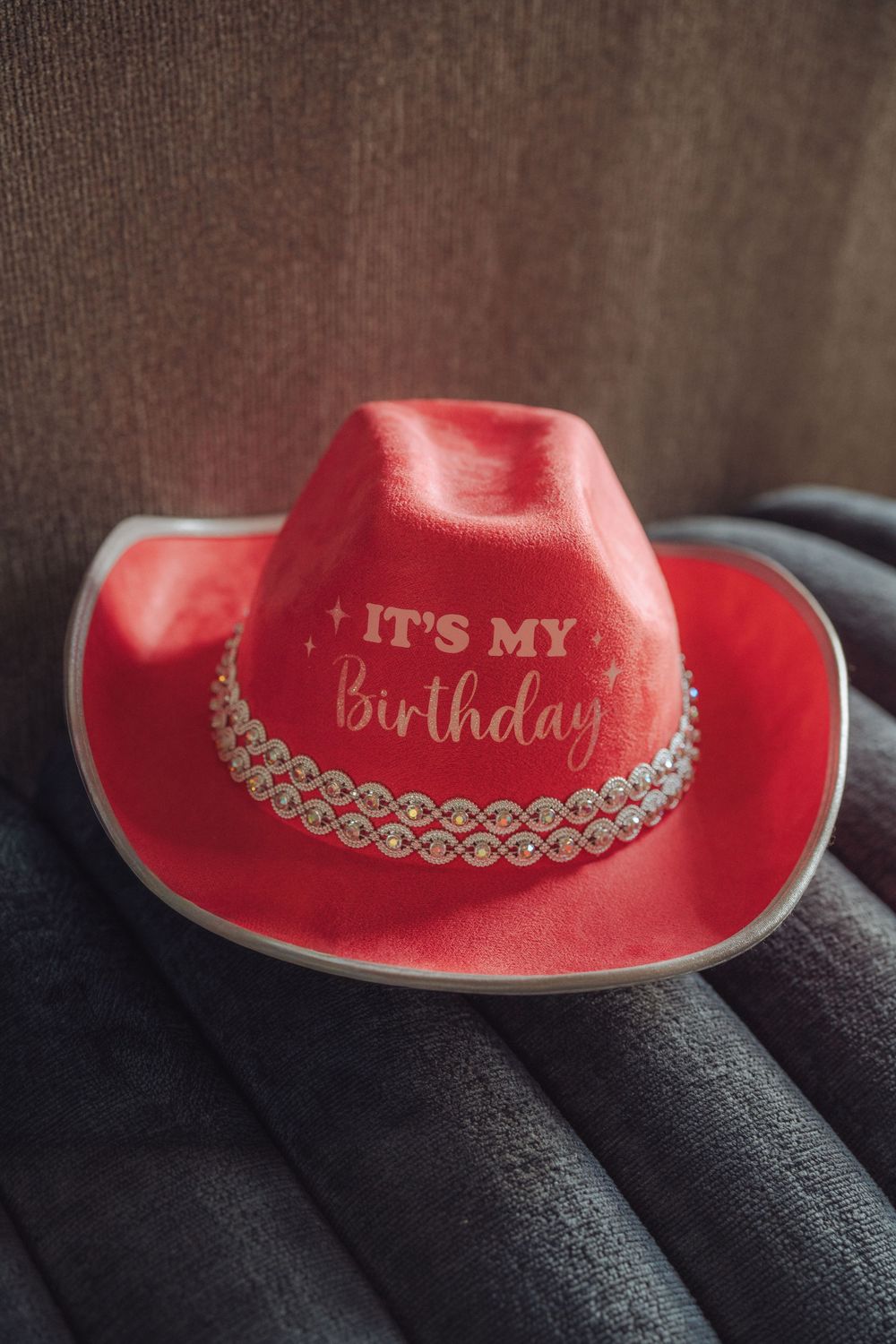 Red cowboy birthday hat with rhinestone trim and "It's My Birthday" text, perfect for celebrations.