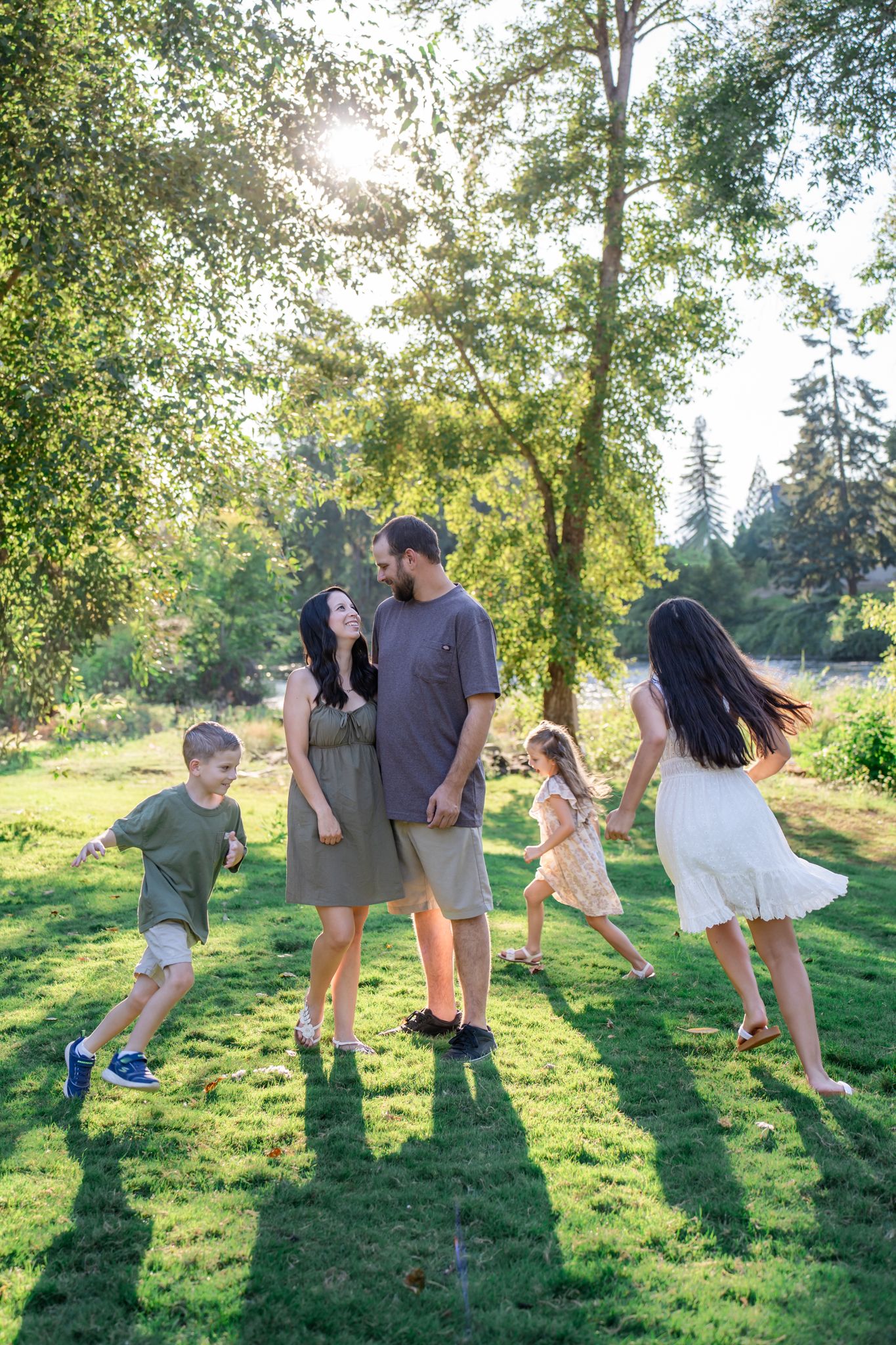 family portrait with kids running around mom and dad