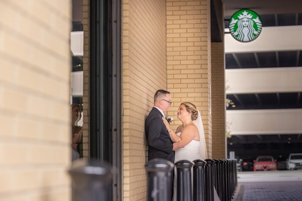 Bride and Groom share embrace outside of a Starbucks