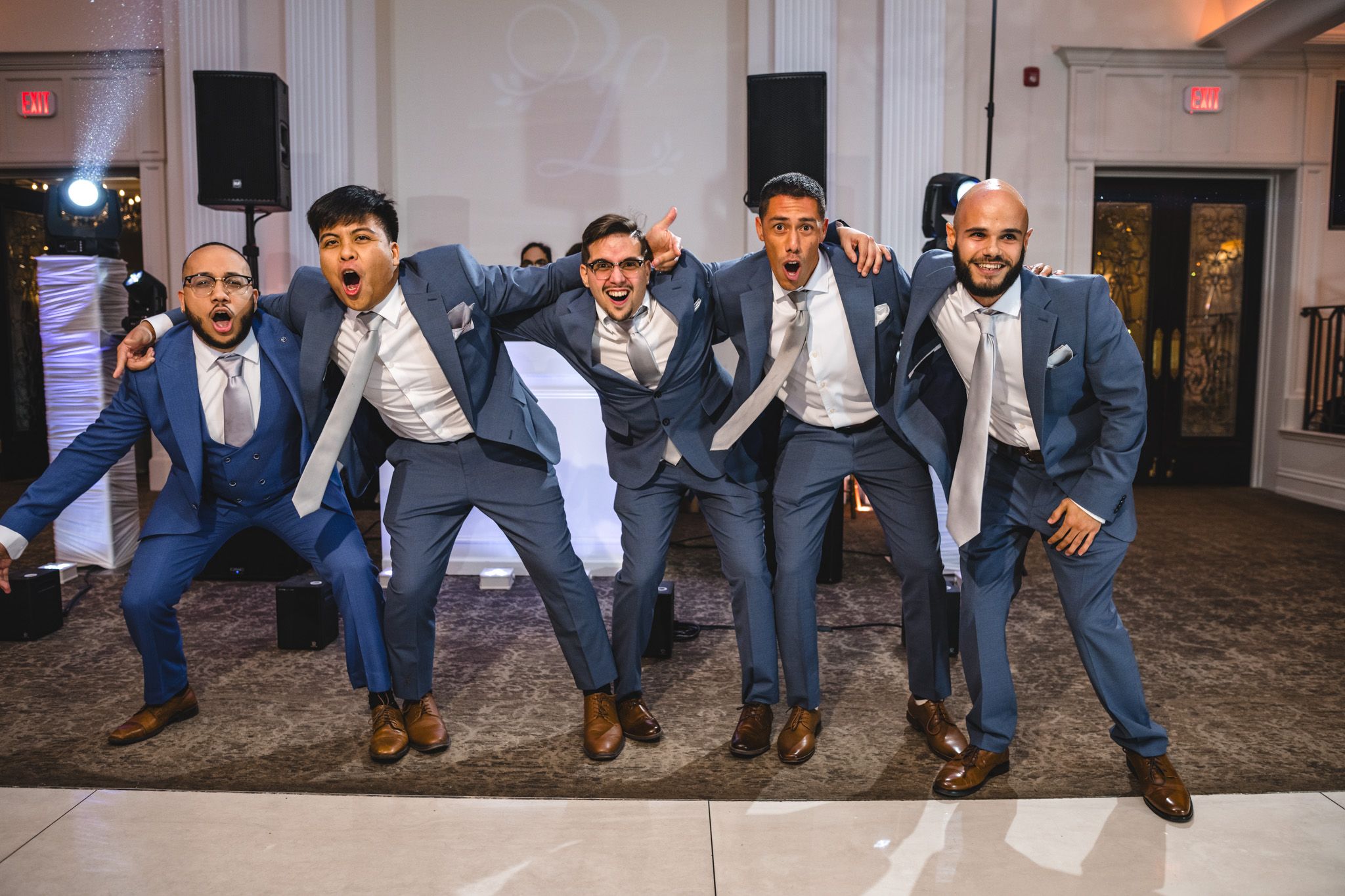 Group photo showing dress shoes and pant legs in coordinated navy blue and gray.