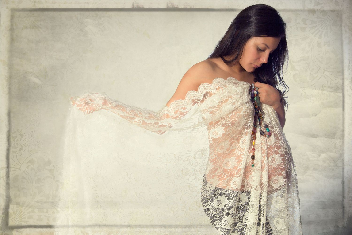 Elegant Maternity Portrait with Lace, A maternity portrait of a woman draped in delicate white lace, colorful beads