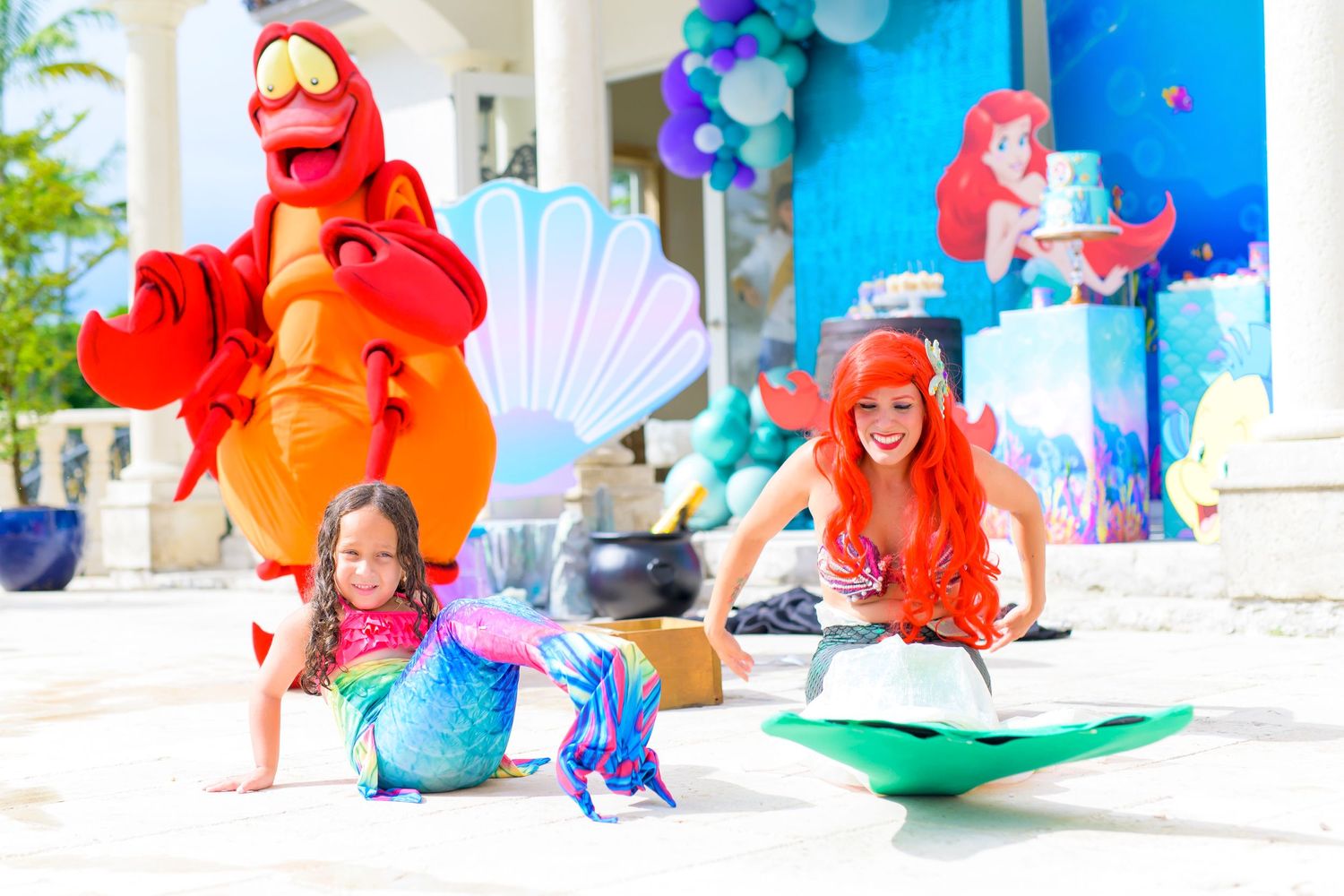 Vibrant character performance at outdoor party with colorful balloon decorations.